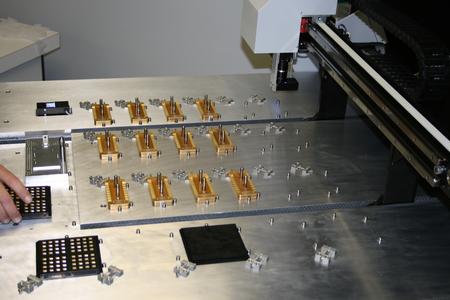 Custom pick-and-place machine used to precisely place micro-lasers for burn in, test and assembly